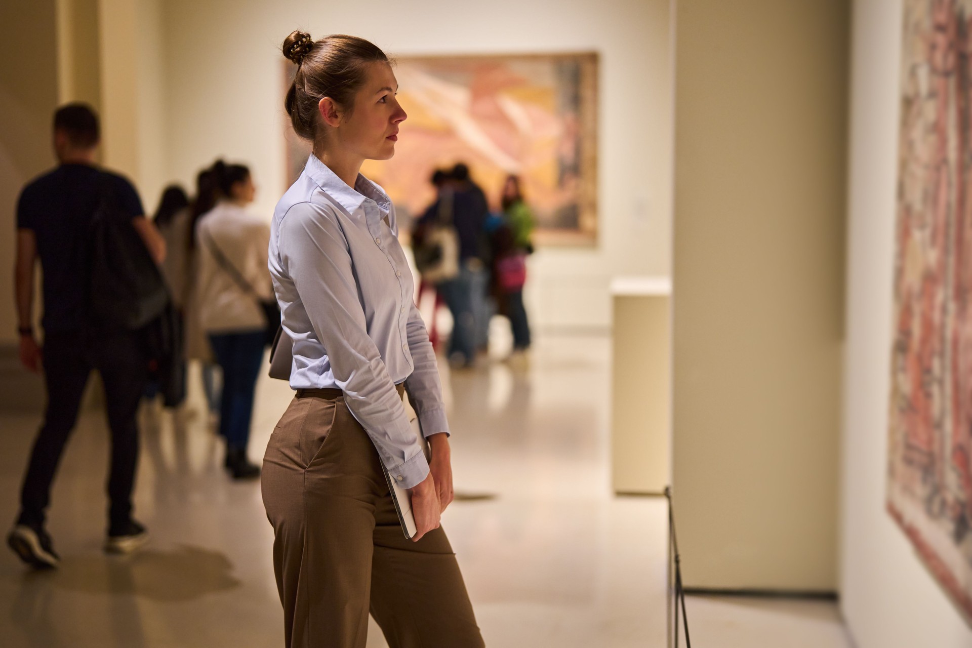 visitor in historical museum looking at art object