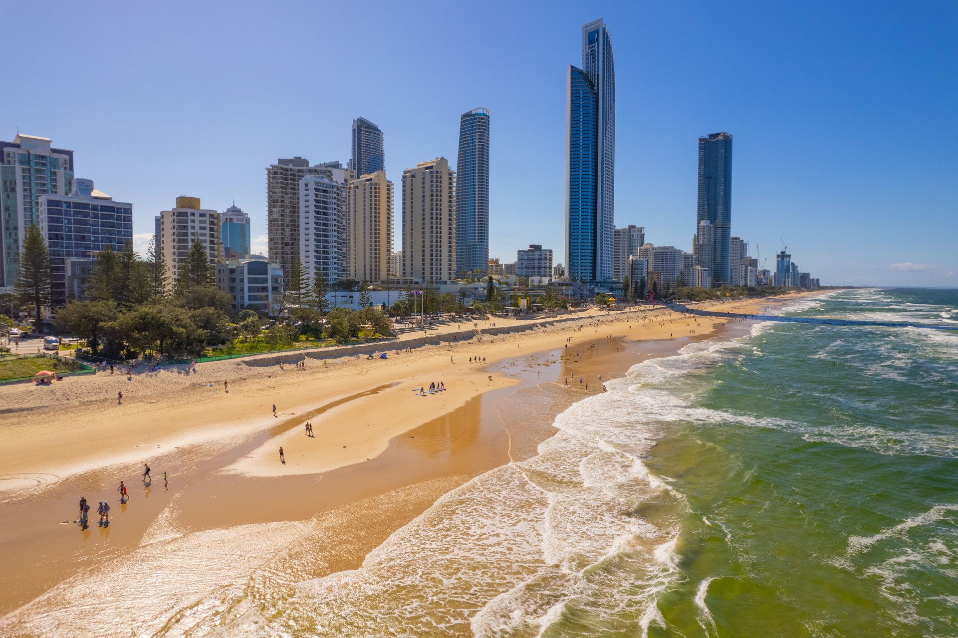 Tourists return to Surfers Paradise after the beach suffered storm damage and sand erosion caused by Cyclone Alfred