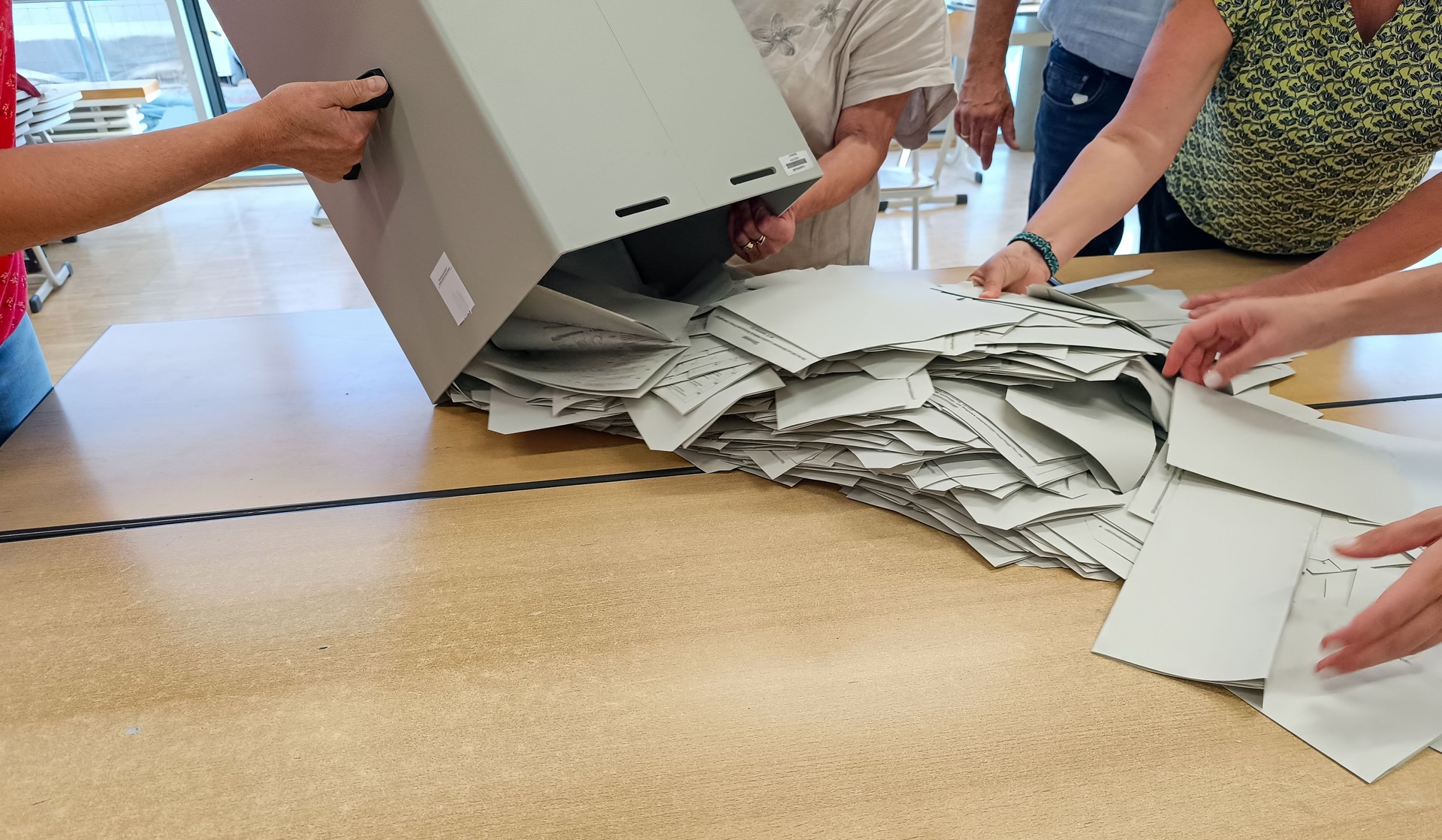 The ballot papers are spread out from the ballot box for counting