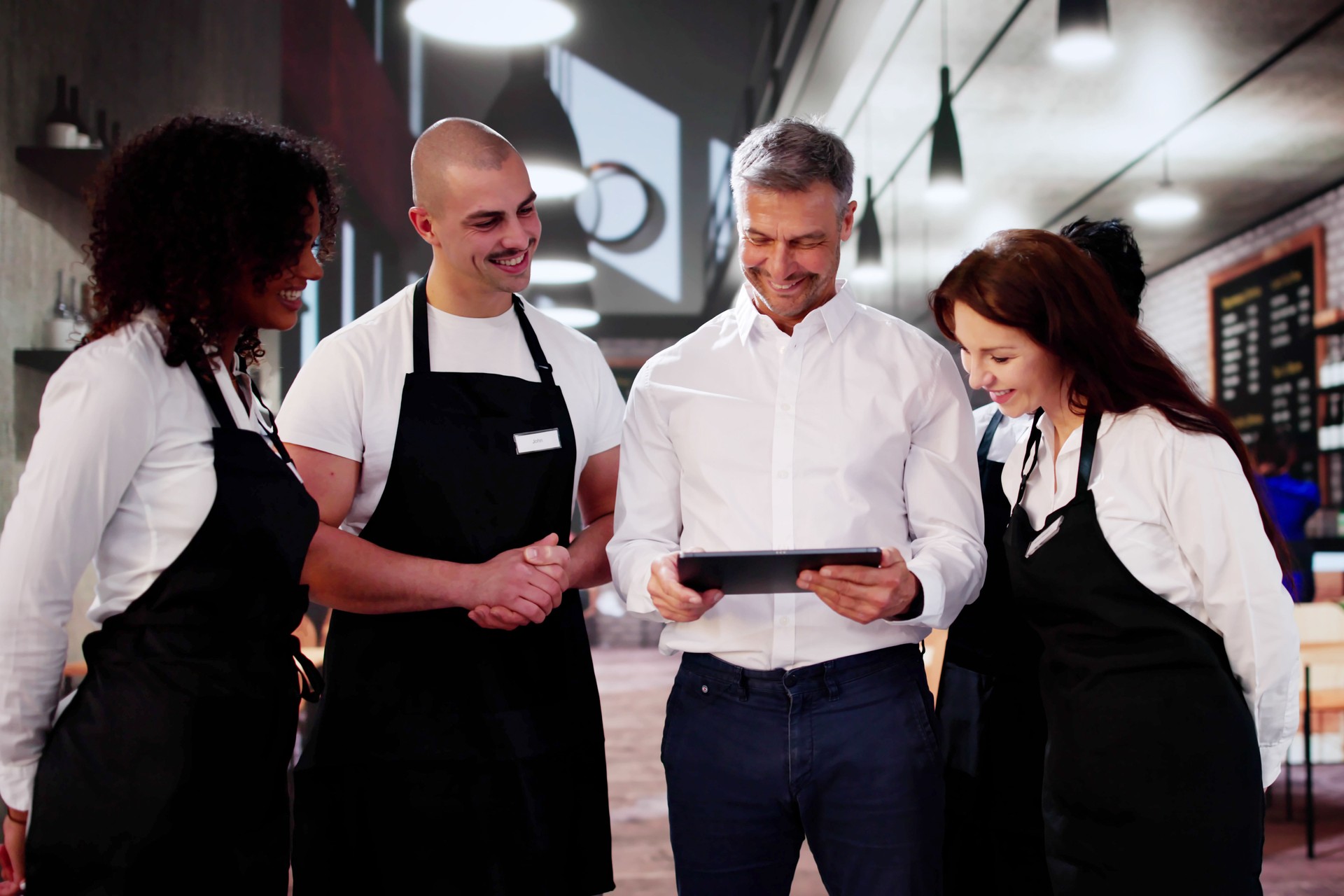 Store Manager In Coffee Shop Meeting With Team